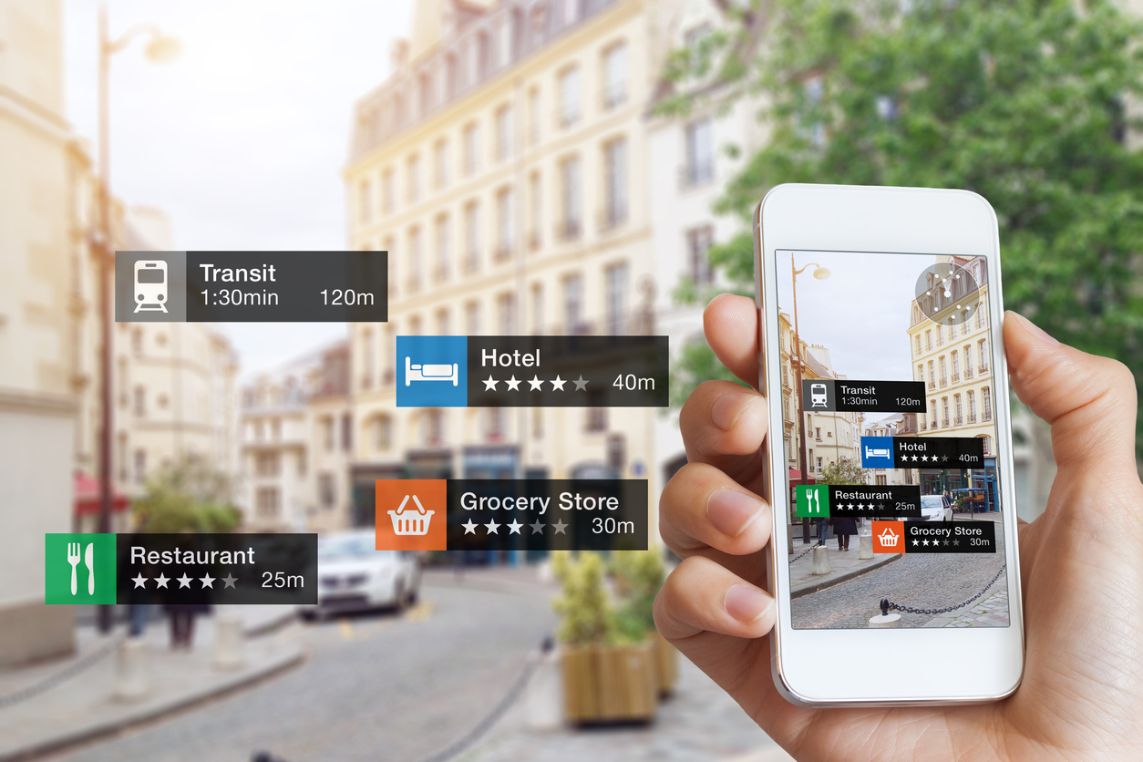 Augmented Reality (AR) information technology about nearby businesses and services on smartphone screen guide customer or tourist in the city, close-up of hand holding mobile phone, blurred street